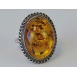 A silver and Baltic amber ring, hallmarked 925, cabachon approx 2.3 x 1.7cm, size R.