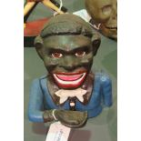 A contemporary cast metal 'Jolly Nigger' money bank with hinged arm, 16cm high.