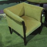 A c1930s square shaped tub chair raised over square taping legs terminating in brass casters,