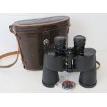 A pair of Canon 7 x 50 binoculars in brown leather case.