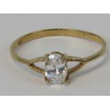 A 9ct gold ring, central oval white stone in claw setting, stamped 9ct, size O.