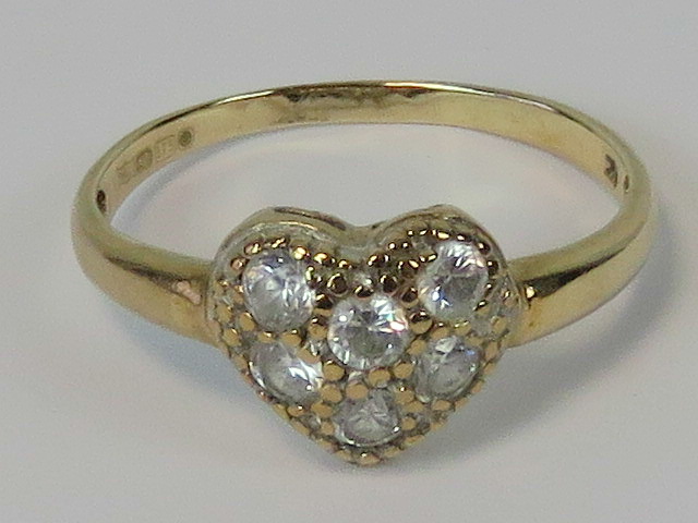 A 9ct gold ring in the form of a heart set with six round cut white stones, hallmarked 375, size Q,