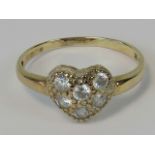 A 9ct gold ring in the form of a heart set with six round cut white stones, hallmarked 375, size Q,