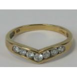 A 9ct gold wishbone ring set with seven round cut white stones, hallmarked 375, size M, 1.7g.