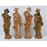 Two pairs of modern Oriental designed resin figures, in standing poses, the highest 25cm,