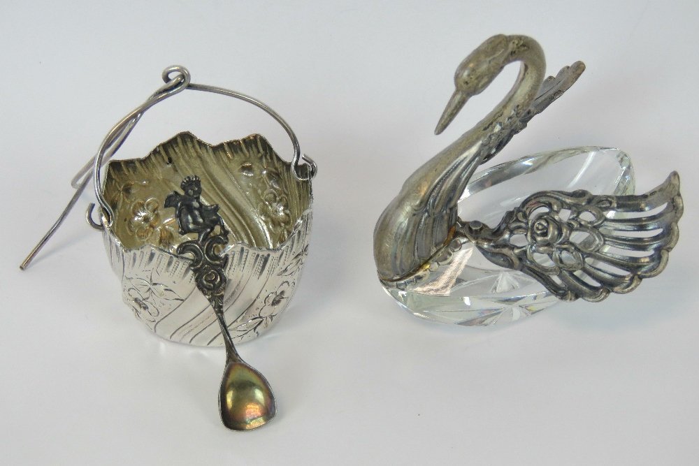 A HM silver salt in the form of a swan, silver head and articulated wings over a cut glass body.