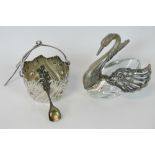 A HM silver salt in the form of a swan, silver head and articulated wings over a cut glass body.