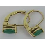 A pair of 10ct gold and marquise cut emerald earrings, stamped 10k, hinge closure.