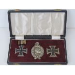 A WWI German Panzer Award Set in case with tank badge and two Iron Crosses.