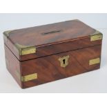 A mahogany money box with brass corners, escutcheon and bracing.
