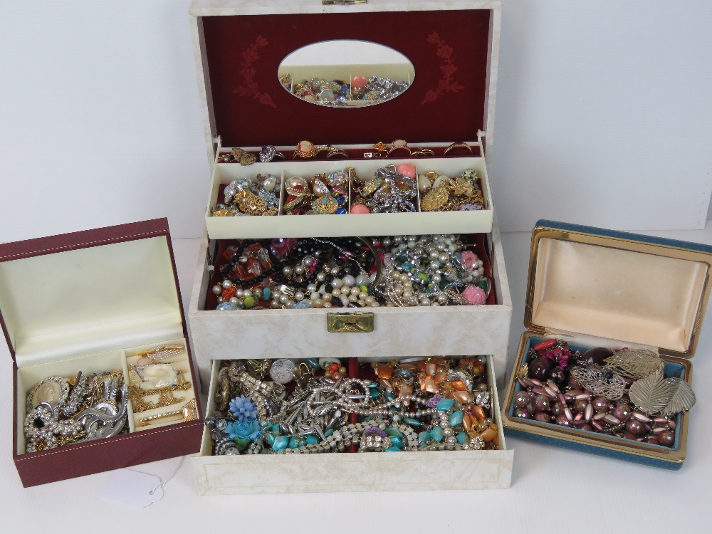 A large quantity of assorted costume jewellery within three vintage jewellery boxes.