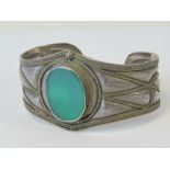A silver cuff bangle with large central green oval agate panel, approx 4cm wide, stamped 925.