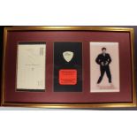 Elvis Presley display containing a postcard signed by him and a guitar pick used by him in concert,