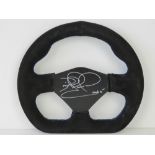 A racing car steering wheel, black suade bound and signed by Nigel Mansell.