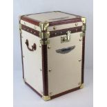 A single Army and Navy type cream leather lidded trunk with brown leather trim and brass corner