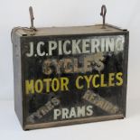 A vintage illuminated box sign for 'JC Pickering Cycles, Motorcycles and Prams.