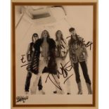 Photo of "The Darkness" signed by them all, 24cm x 39cm. SIA.