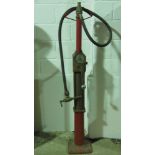 A vintage 1930s brass and cast iron hand crank petrol pump.