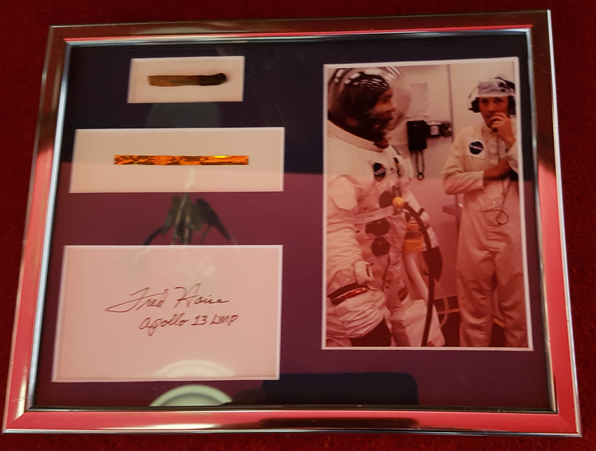 Fred haise (Apollo 13) Display containing two pieces of heat shield from Apollo 13's ill fated