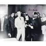 Photo of Lee Harvey Oswald just before he was shot signed by James Leavelle,