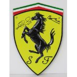 A cast metal 'Ferrari' shield sign signed by Mansell and Brooks.
