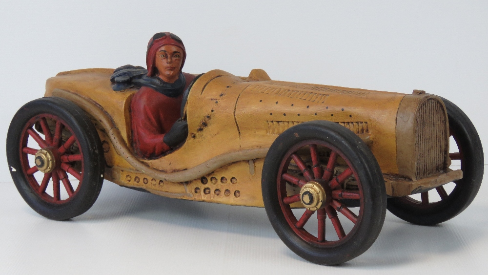 A contemporary decorative model of a vintage racing car with driver, 55cm.