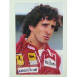 An Alain Prost signed coloured photograh, mounted, 30cm x 19cm.