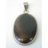 A silver and oval brown chalcedony penda