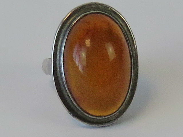 A silver and amber cabachon ring, indist