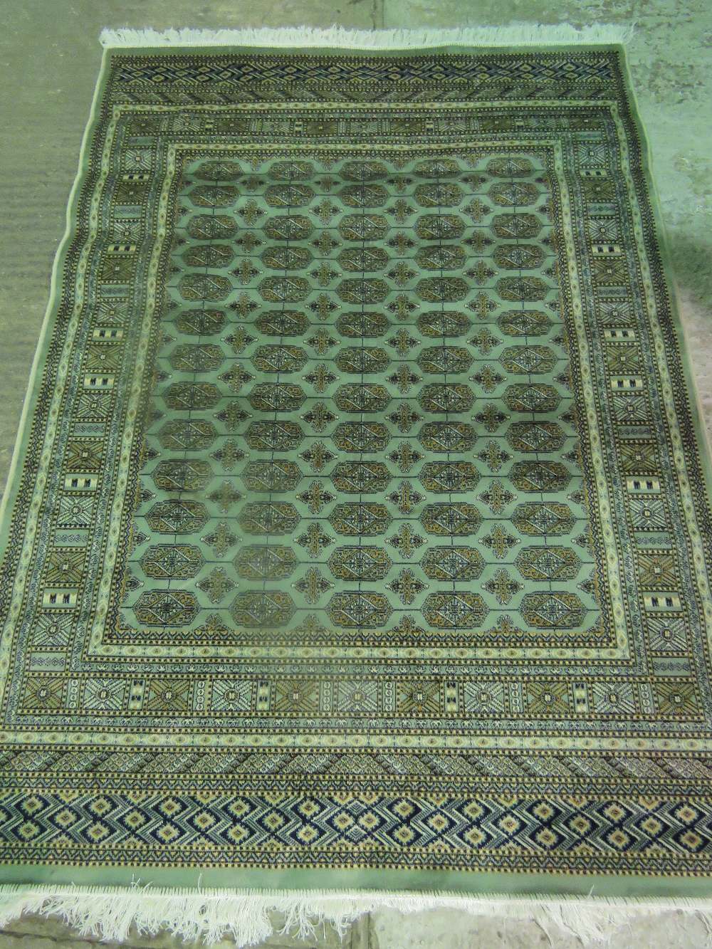 A green ground bokhara rug; 190cm x 140c