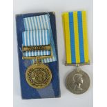 A Korea medal and a UN Korea medal in box, both with ribbons, one stamped 22559084 GNR. C.H.Scarth.