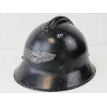 A WWII German Luftshutz 'Home Guard' helmet, with original liner and chin strap.