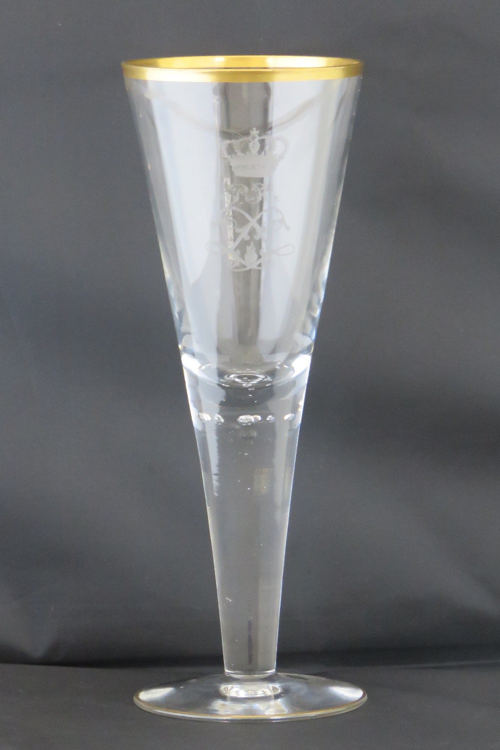 A large Imperial German conical glass wine goblet with etched regimental decoration and gilt rim