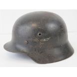 A WWII German Luftwaffe helmet, single decal with original liner and chin strap.