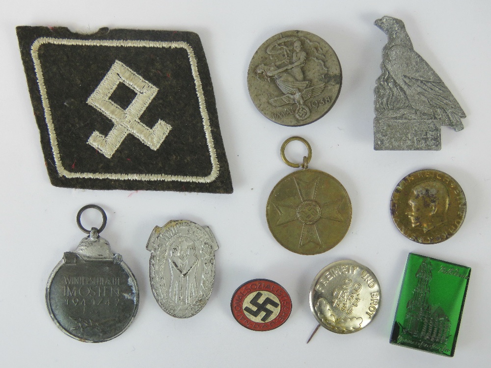 Ten WWII German badges and medals including; party badge marked RZM M1/120.