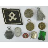 Ten WWII German badges and medals including; party badge marked RZM M1/120.