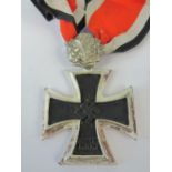 A WWII German Knights Cross with oak leaves and ribbon.