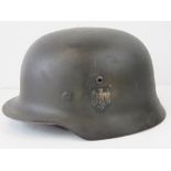 A WWII German Army helmet, single decal, with replacement liner and chin strap.