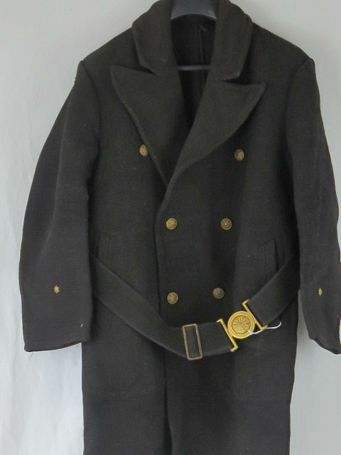 A WWII Japanese Navy coat, label inside, complete with brass buttons and belt with brass buckle.