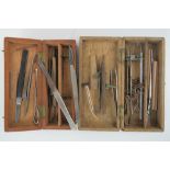 Two boxed travelling dentistry/surgery kits, with scalpels, tweezers,
