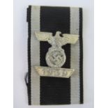 A WWII German Iron Cross bar with ribbon.