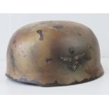 A WWII German Paratrooper helmet, single Luftwaffe decal, later painted desert camo,