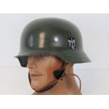 A reproduction WWII German helmet - film prop.