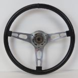 A c1960s vintage Les Leston steering wheel having three spoke aluminium boss, monogrammed LL,