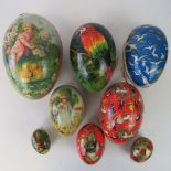 Eight cardboard 'eggs' each in two halves, handpainted with various scenes upon,