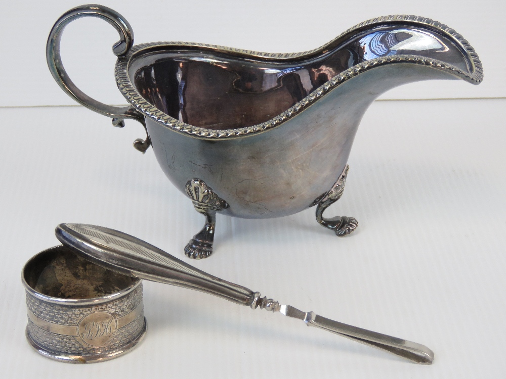 A HM silver napkin ring, a pair of tweezers with HM silver handle, and a silver plated sauce boat.