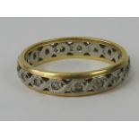 An 18ct gold and platinum eternity ring, central platinum band set with white stones,