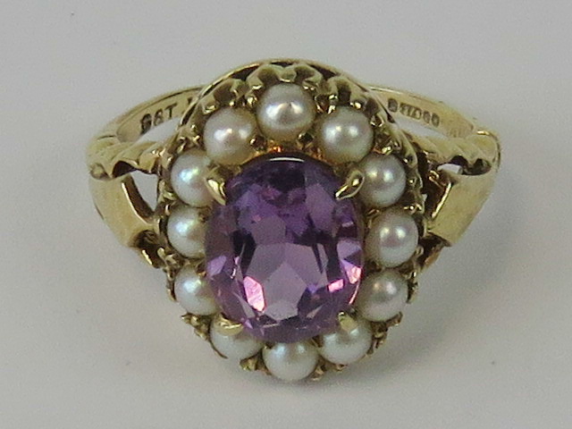 A 9ct gold amethyst and seed pearl ring, central oval cut amethyst approx 1.