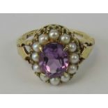 A 9ct gold amethyst and seed pearl ring, central oval cut amethyst approx 1.