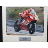 A coloured photograph signed by Loris Capirossi, Ducati MotorGP 2007, mounted, 28cm x 36cm.